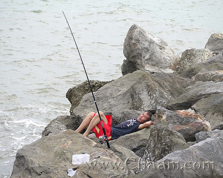 Tired angler in Cha-Am fishing village